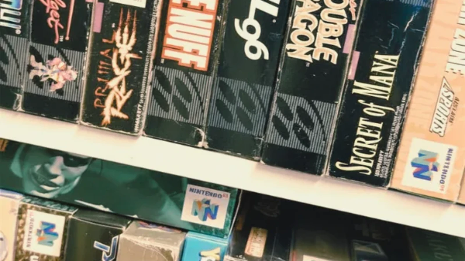 Boxed Super Nintendo and Nintendo 64 games on a collector's shelf